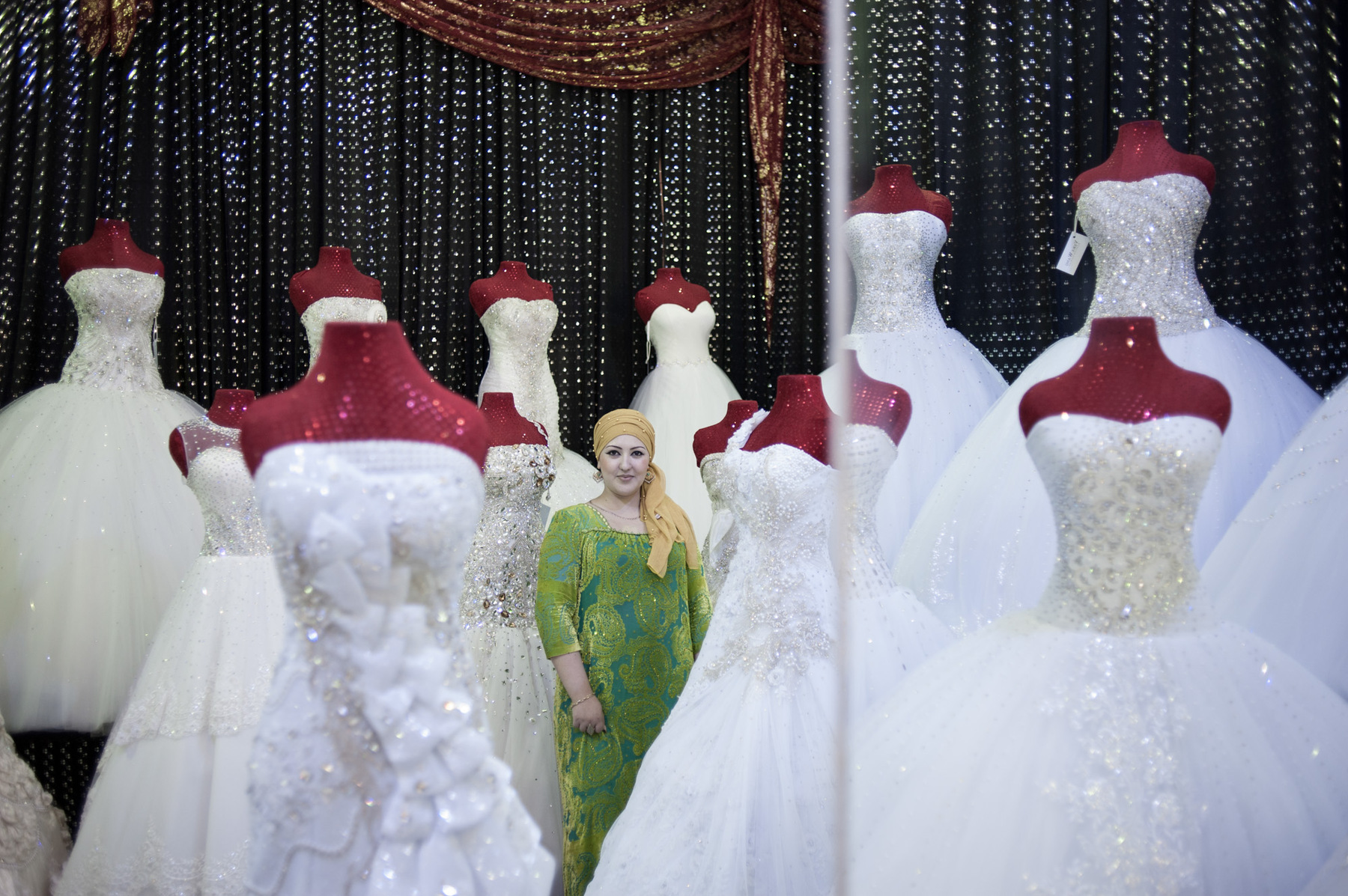 Konstantin Salomatin - 03 Manijabonu Tursunova – wedding saloon owner. The dresses come from Ukraine, Turkey, and some of them she makes herself. Dress rental price is between 100 to 1000$ and selling prices are between 500 to 1500$. ‘People like glam and go after glossy things. After each rental we take the dresses to a dry cleaning. The usual rental is for 2 days’. She makes the dresses herself – orders textiles and bodices and make the dress. It takes about 2 days to finish one dress. She always liked weddings. Manijabonu is a designer herself, born in Khujand. She went to a professional school. 10 years ago she was featured at a Atlas show of traditional and dinner dresses. After that in 2007 she moved to Dushanbe and opened the saloon. The major investment went towards the first shipment of dresses and the rental of the shop. Started with a bank loan, she already returned the investment and now owns two saloons. ‘I have about 40-50 clients a month and 3 out of which would buy something’.